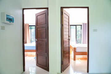 Wooden teak door open to modern new house bedroom