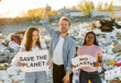 © prostooleh - Ecology activists holding signs agains pollution at trash pill