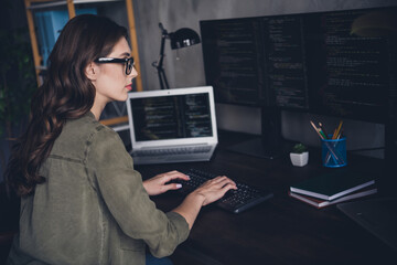Wall Mural - photo of serious confident lady hacker wear eyeglasses writing binary code modern gadget indoors wor