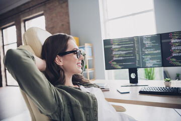 Wall Mural - photo of smiling positive lady hacker wear eyeglasses arms hands behind head having rest indoors wor