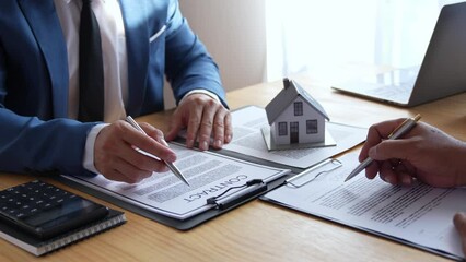 Wall Mural - Discussion With A Real Estate Agent, a businesswoman signing a contract for Insurance protecting house, a real estate home is pointing to insurance contract signing and are explaining to customers.