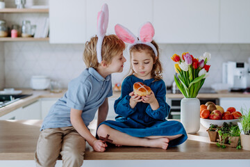 Wall Mural - Little siblings enjoying easter time together in home.