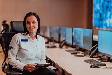 Wall Mural - Female security operator working in a data system control room offices Technical Operator Working at workstation with multiple displays, security guard working on multiple monitors