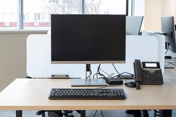 Сomputer desks and desktop computer in the office, display screen and phone for mock-up