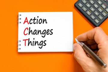 Wall Mural - ACT action changes things symbol. Concept words ACT action changes things on white note on a beautiful orange table orange background. Business and ACT action changes things concept. Copy space.
