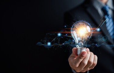 Fototapete - Businessman holding light bulb for business analysis management, Idea and imagination, innovation development leadership, Solution analysis and development, Innovative technology.