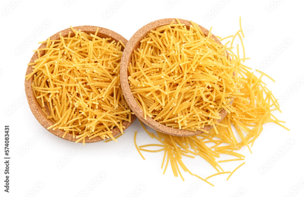 Plates of raw vermicelli pasta on white background