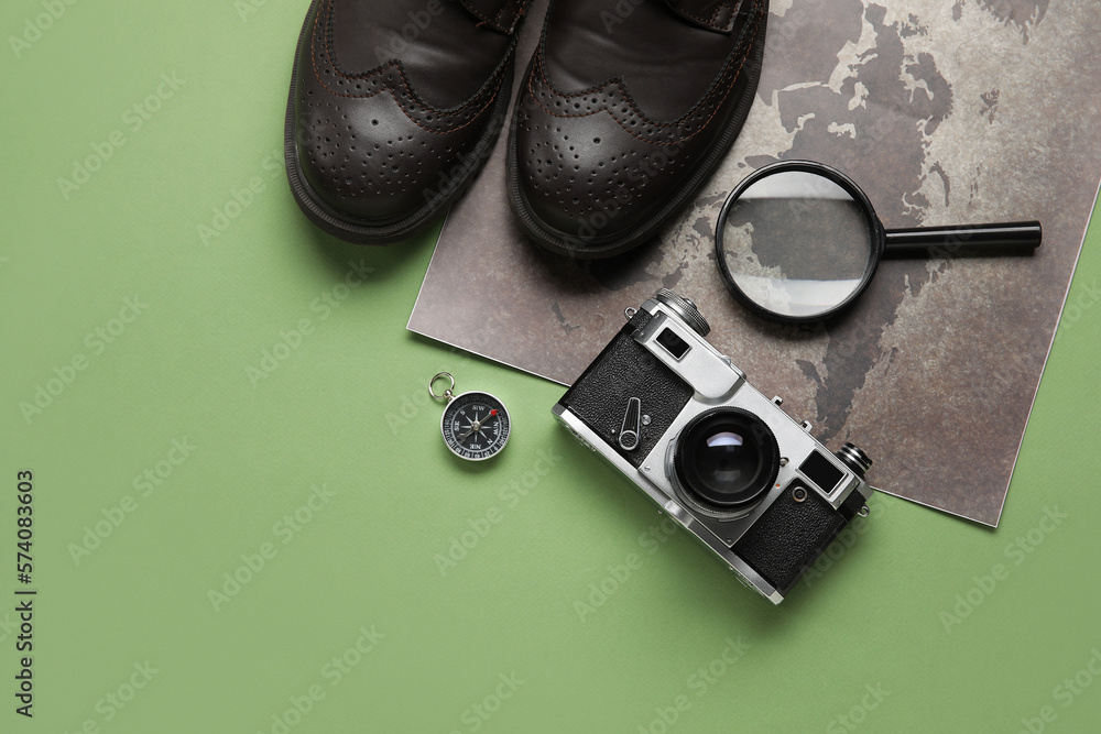 Compass with traveler accessories on green background