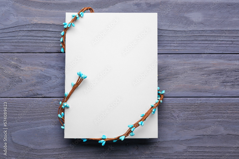 Blank greeting card with vine on grey wooden background