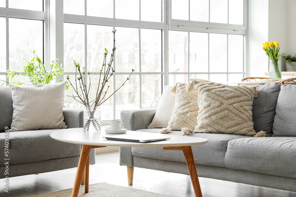 Grey sofas with stylish cushions in interior of living room