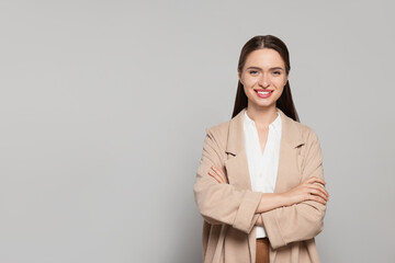 Canvas Print - Portrait of beautiful young teacher on grey background. Space for text