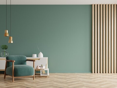 living room with green armchair on empty dark green wall background.