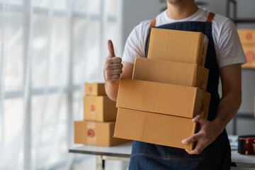 Small Business Startup Owner Asian Independent Entrepreneur Arranging multiple parcel boxes on online orders for delivery arrangements to customers, SME business concept.