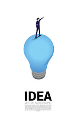 Poster - Silhouette of businessman standing and point on light bulb . Business Concept of creative idea and solution.