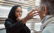 Optometry, vision and eye test with an islamic woman optician working to diagnose a customer. Doctor, optometrist and eyecare with a muslim female testing a client for prescription lenses in a clinic