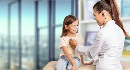 Wall Mural - Young doctor checking small child