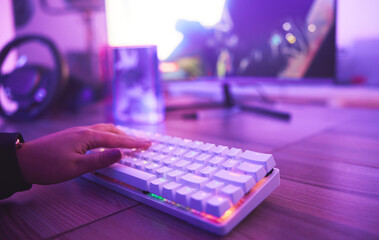 Leinwandbilder - PC keyboard, gaming and hand for video game, online streaming and gamer room in neon light. Woman or person hands typing or press keys on gamer electronics, computer technology and rgb lights closeup