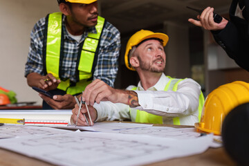 Wall Mural - Civil Construction team working at renovate construction site. architectural plan, engineer sketching a construction project, green energy concept.