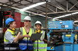 © feeling lucky - Architect men and worker checking and pointing at heavy industry manufacturing factory with computer. Multiethnic business manager looking in future with warehouse factory building