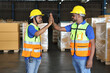 © feeling lucky - Happy smiling teamwork with hardhats and reflective jackets give high five celebrate successful together completed deal commitment at retail warehouse logistics, distribution center, success concept