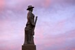 Silhouette of Aussie soldier keep silent against dramatic sunset sky with clouds in the outback of Queensland, Australia.