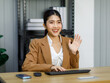 © Bangkok Click Studio - Millennial Asian young professional female businesswoman employee secretary staff officer in formal business suit and eyeglasses sitting typing keyboard working online with computer at workstation