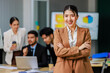 © Bangkok Click Studio - Portrait of a happy Asian young professional successful female businesswoman in formal business suit standing pose working in company office