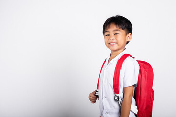 Asian adorable toddler smiling happy wearing student thai uniform standing in studio shot isolated on white background, Portrait little children boy preschool, Happy child Back to school