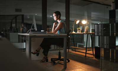 Wall Mural - Computer reading, night and African woman review article for social media app, digital website or online blog. serious employee, research thinking and profile journalist working overtime on news post