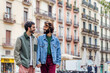 © Raul Mellado - gay male couple walking through the city holding hands, concept of freedom and love between people of the same sex, copy space for text