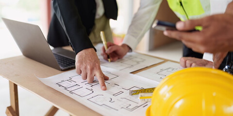 Wall Mural - Civil Construction team working at renovate construction site. architectural plan, engineer sketching a construction project, green energy concept.