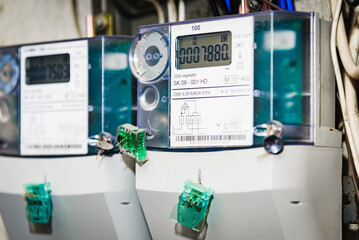 Kilowatt hour electric meters, power supply meters.Close-up of modern smart grid residential digital power supply meter.Indoors shot.Selective focus.
