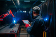 © bernardbodo - Engineer using robotic welder control panel.