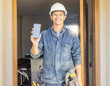 © Lumeez/peopleimages.com - Construction worker, man in portrait and phone, screen with mockup and contact, digital marketing and handyman. Home renovation, maintenance and industry trade promo with product placement advert