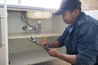 © Lumeez/peopleimages.com - Plumber writing, sink maintenance document and plumbing check of a handyman in a kitchen. Water installation, home repair checklist and builder in a household for building construction and inspection