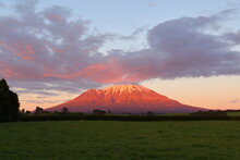 Sunrise With Beautiful Pink Clouds At The Stratovolcano Mt. Taranaki In The Egmont National Park Of New Zealand