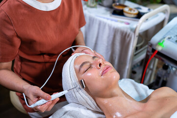 Beautiful young woman lying down on massage beds at luxury massage and spa and wellness center