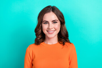 Canvas Print - Closeup portrait of young charming positive smiling lady brown curly hairstyle wear orange stylish top good mood isolated on cyan color background