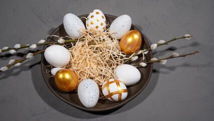 Wall Mural - HAPPY EASTER holiday celebration backgroud banner - Easter nest with gold painted easter eggs and catkins on concrete table texture, top view......