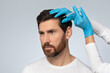 © Prostock-studio - Middle aged man getting hair treatment at beauty salon, having mesotherapy session, grey background