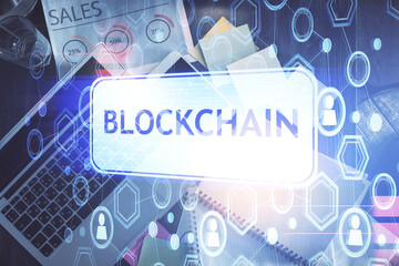 Fototapete - Blockchain theme hologram drawings over computer on the desktop background. Top view. Double exposure.