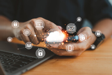 Fototapete - businessman in an office working on his smartphone and selecting the cloud icon on a virtual display. This symbolizes the use of digital technology and cloud technology.