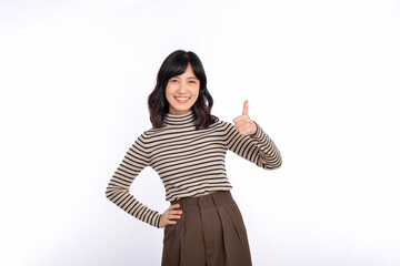 Young confident asian woman with sweater cloths showing thumb up in approval, recommending, standing isolated on white background