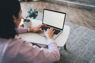 Canvas Print - Anonymous woman typing on laptop keyboard