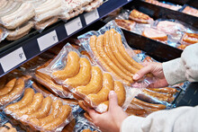 Sausages In Hands Of Buyer In Shop