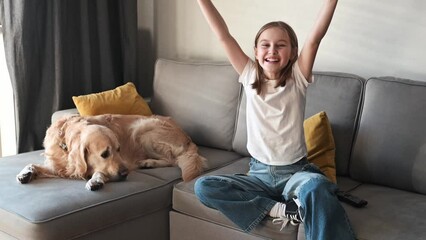 Wall Mural - Preteen girl with golden retriever at home