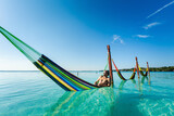Fototapeta Miasto - Man on hammock in Bacalar lagoon Mexico