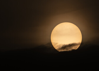Wall Mural - The sun slowly hides in the misty sunset!