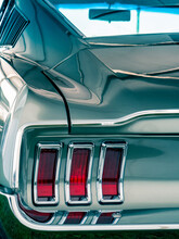 Rear Photo Of An Old Classic Muscle Car In Silver Paint With Taillight Visible