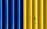 Fototapeta Dmuchawce - Blue and yellow container close-up